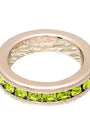 Ring with green gemstones on a white background