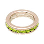 Ring with green gemstones on a white background