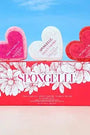 Heart-shaped bath bombs with 'Spongelle' branding against a blue sky background