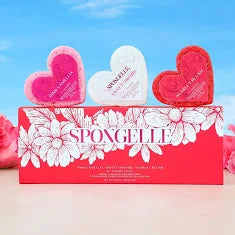 Heart-shaped bath bombs with 'Spongelle' branding against a blue sky background