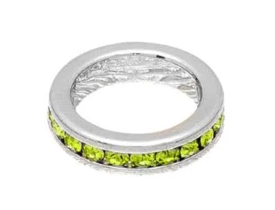 Silver ring with green gemstones on a white background