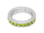 Silver ring with green gemstones on a white background