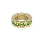 Gold ring with green gemstones on a white background