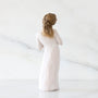 Statue of a woman in a long dress with braided hair on a white background