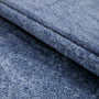 Close-up of blue denim fabric with a visible seam.