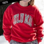 Person wearing a red sweatshirt with 'Lulu Mac' printed on it.
