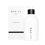 Boujèe scented body oil bottle with packaging on a white background