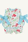 Floral baby romper with blue bows on a white background