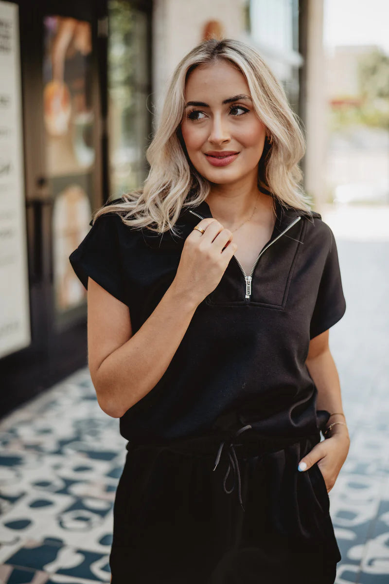 Woman wearing a black outfit with a blurred background