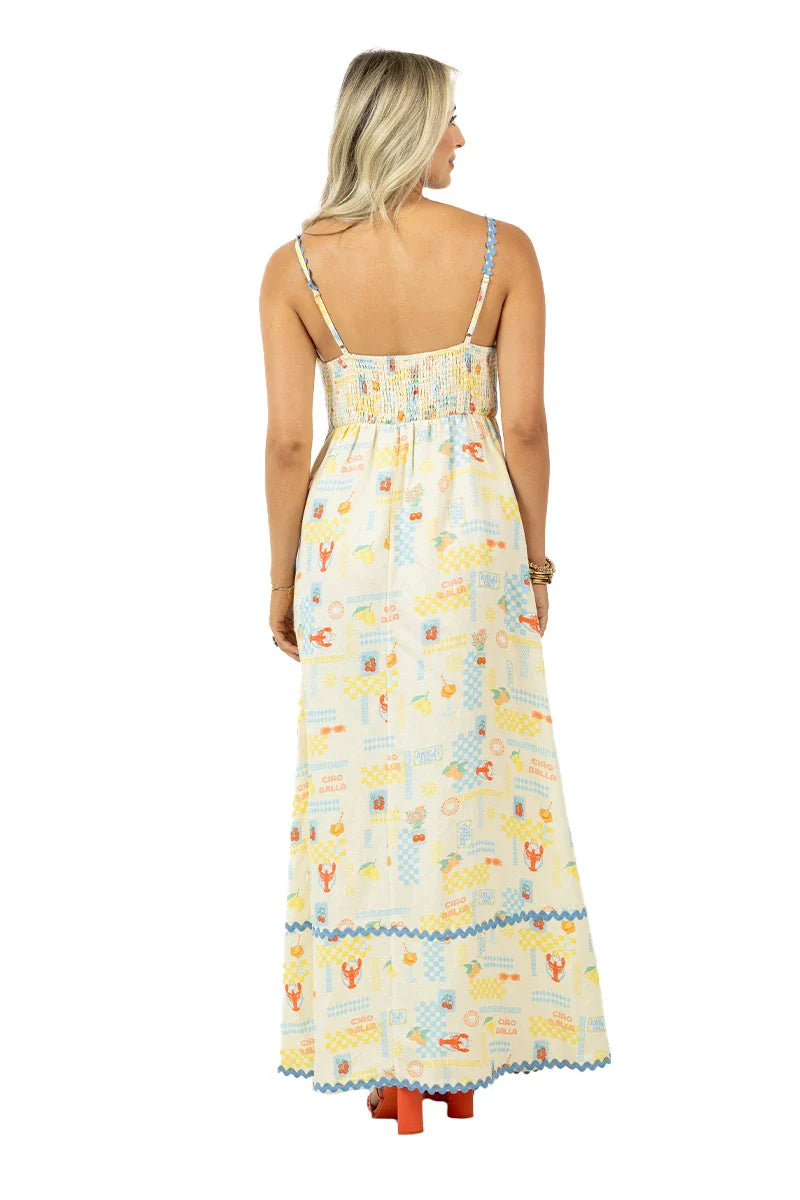 Woman wearing a long, patterned dress on a white background