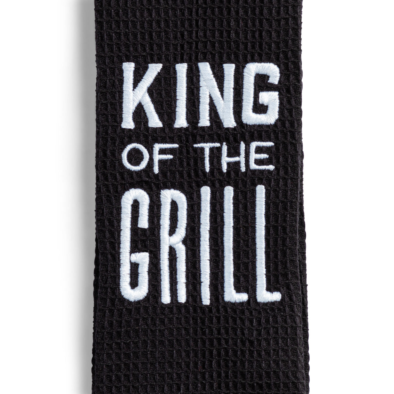 Black towel with 'King of the Grill' text on a white background